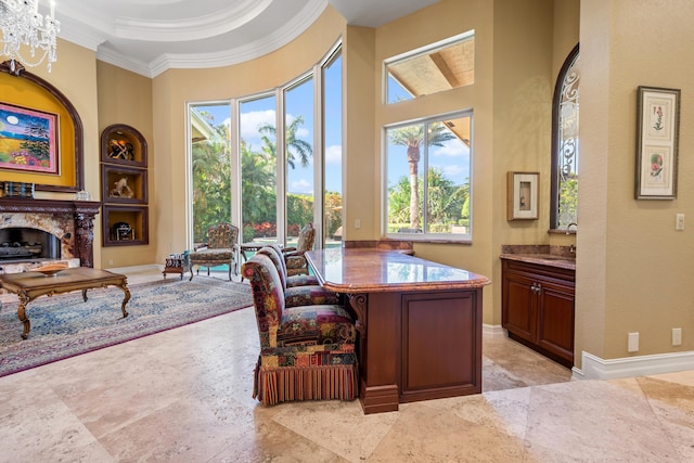 office space with sink, a chandelier, a high ceiling, and ornamental molding