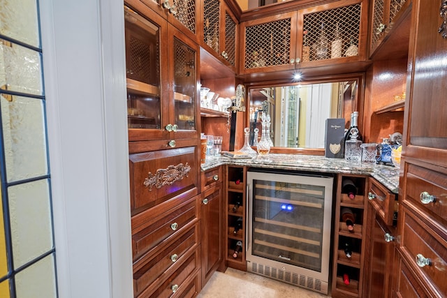 kitchen with light stone counters and beverage cooler