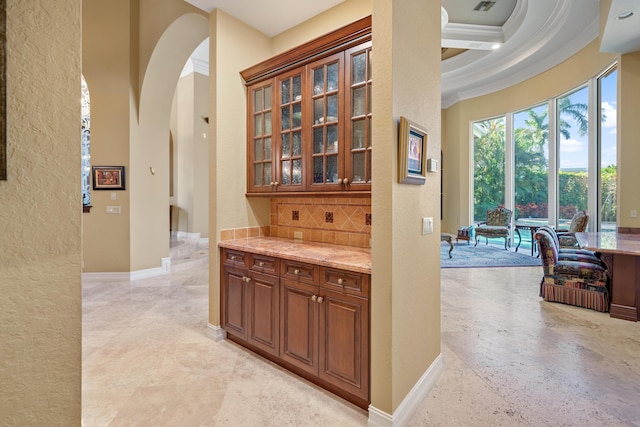 corridor with beamed ceiling, ornamental molding, coffered ceiling, and a high ceiling