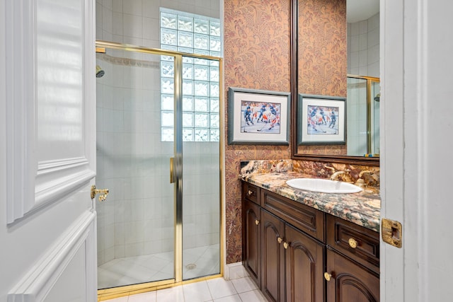 bathroom with tile patterned flooring, vanity, and a shower with door