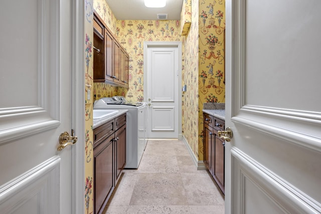 laundry room featuring cabinets and washing machine and dryer