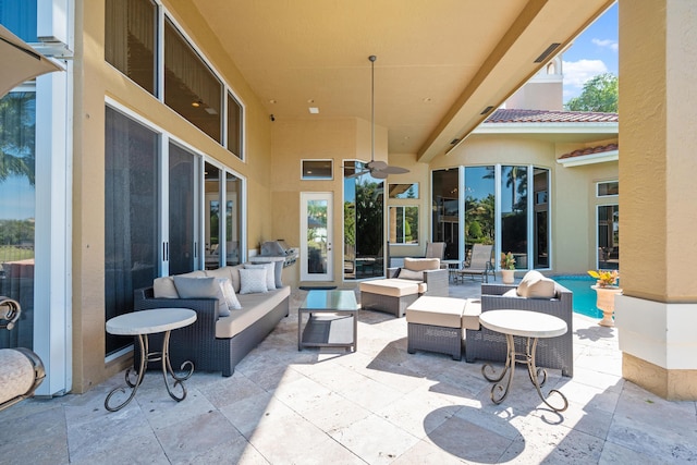 view of patio featuring ceiling fan, a pool, and an outdoor living space