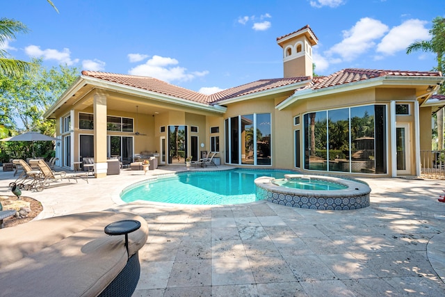 view of swimming pool featuring an in ground hot tub and a patio area