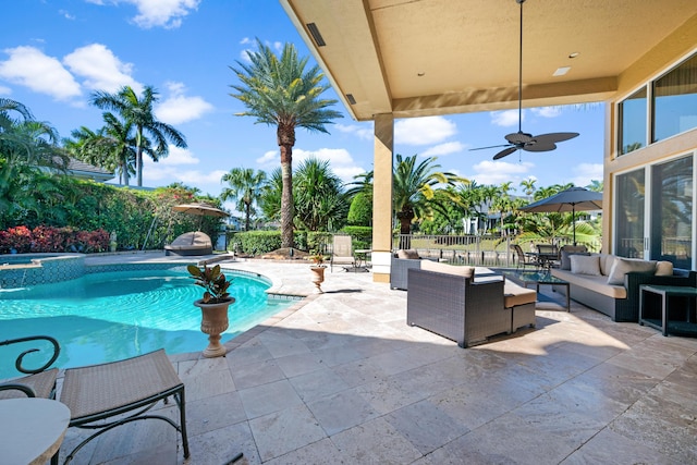 view of pool with outdoor lounge area, ceiling fan, and a patio