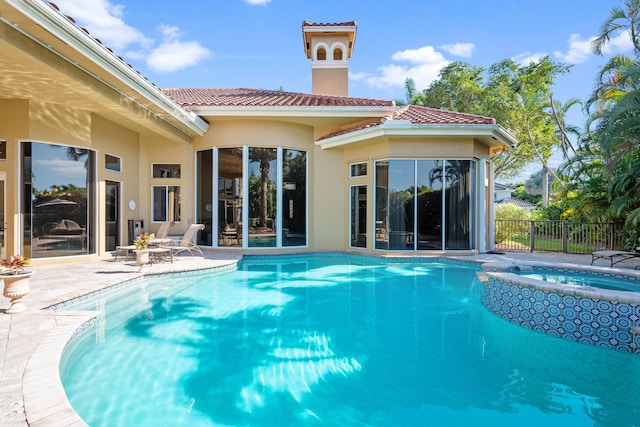 view of swimming pool featuring an in ground hot tub and a patio