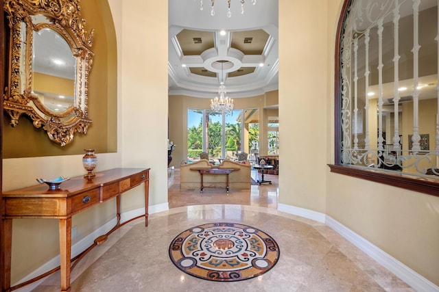 entrance foyer featuring a high ceiling, coffered ceiling, ornamental molding, a notable chandelier, and beam ceiling