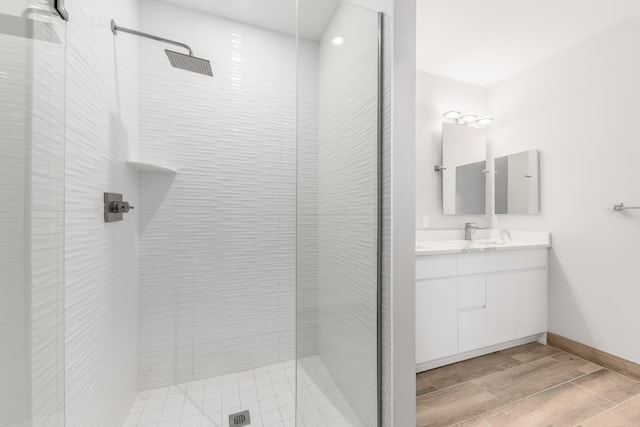 bathroom with vanity and tiled shower