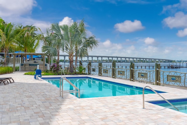 view of swimming pool featuring a patio area and exterior kitchen