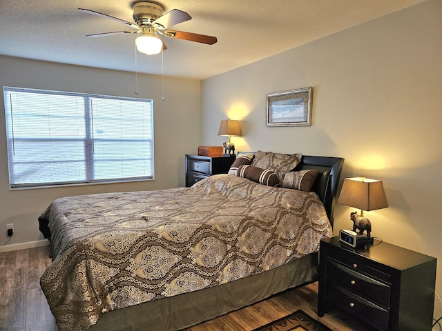 bedroom featuring dark hardwood / wood-style flooring and ceiling fan