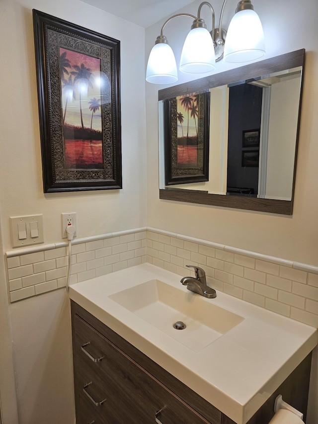 bathroom featuring vanity and tasteful backsplash