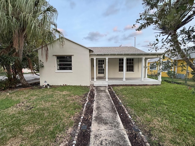 rear view of house with a yard