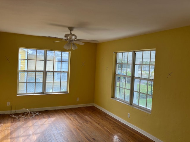 unfurnished room with hardwood / wood-style floors and ceiling fan