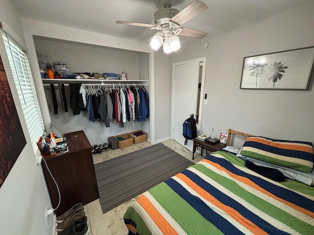 bedroom featuring ceiling fan, a closet, and tile patterned flooring