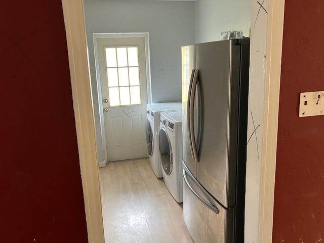 washroom featuring washer and dryer and light wood-type flooring