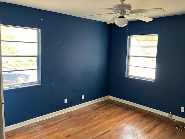 unfurnished room with ceiling fan and wood-type flooring