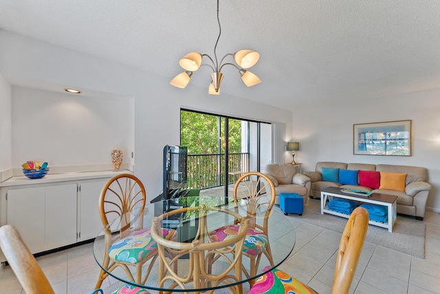 tiled dining room featuring a chandelier and a textured ceiling