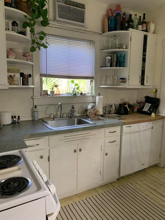 kitchen featuring open shelves, a wall mounted AC, white cabinetry, a sink, and white appliances