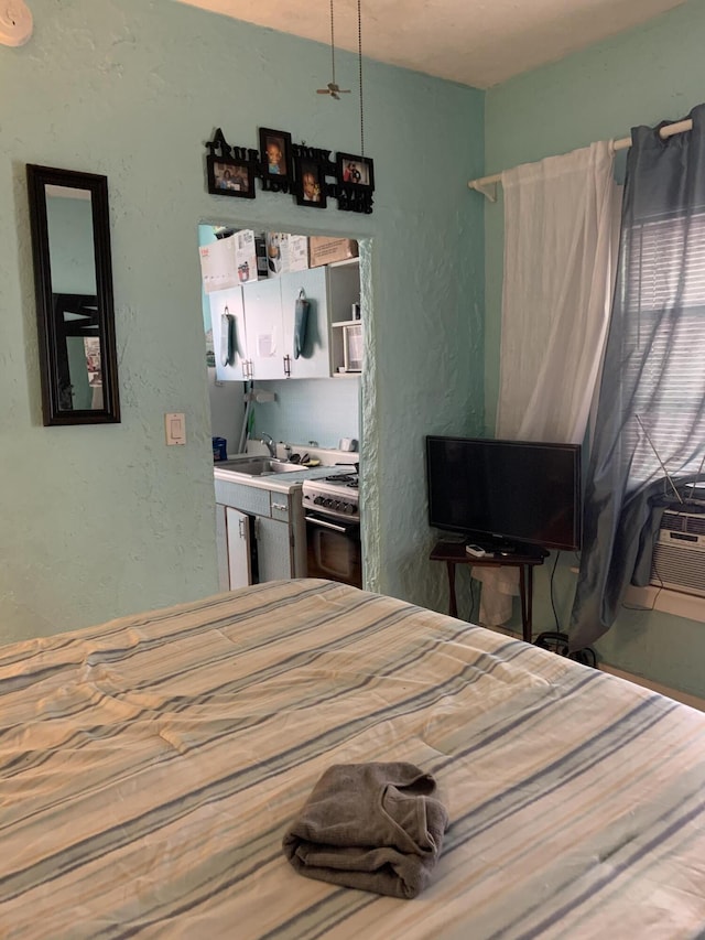 bedroom featuring a sink and a textured wall