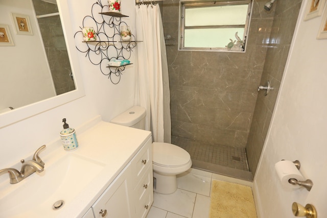 bathroom featuring tile patterned flooring, vanity, toilet, and walk in shower