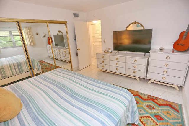 bedroom featuring a closet and light tile patterned floors