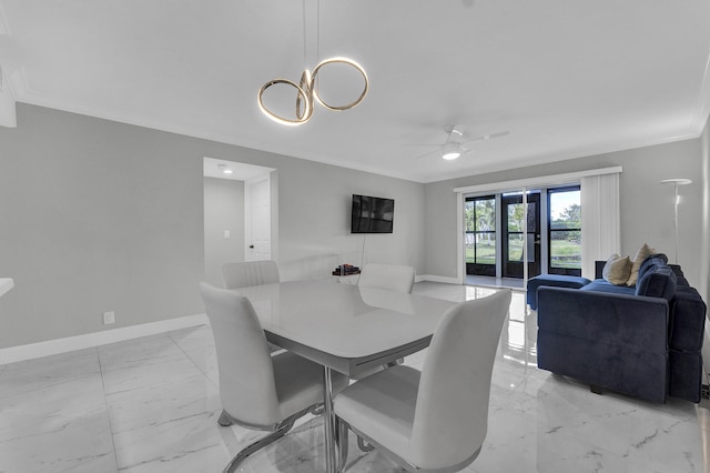 dining area with ceiling fan with notable chandelier and ornamental molding