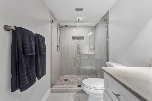 bathroom featuring vanity, toilet, and a shower with shower door