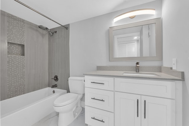 full bathroom featuring vanity, tiled shower / bath combo, and toilet