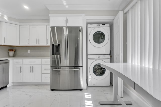 clothes washing area with stacked washer / dryer and ornamental molding