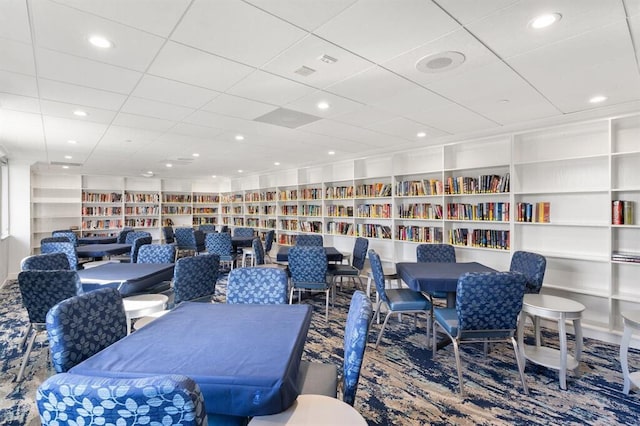 carpeted dining space featuring built in shelves