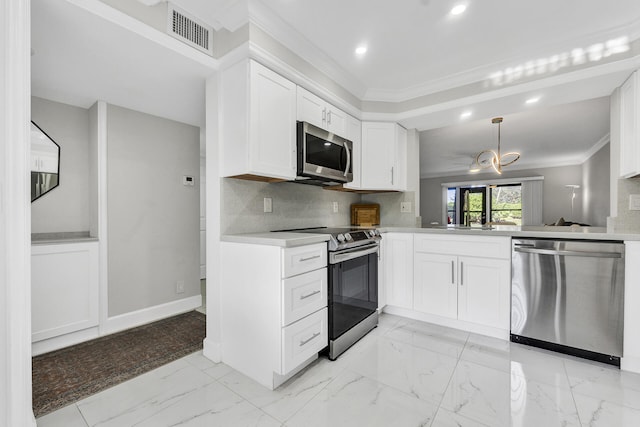 kitchen with white cabinets, stainless steel appliances, kitchen peninsula, and tasteful backsplash