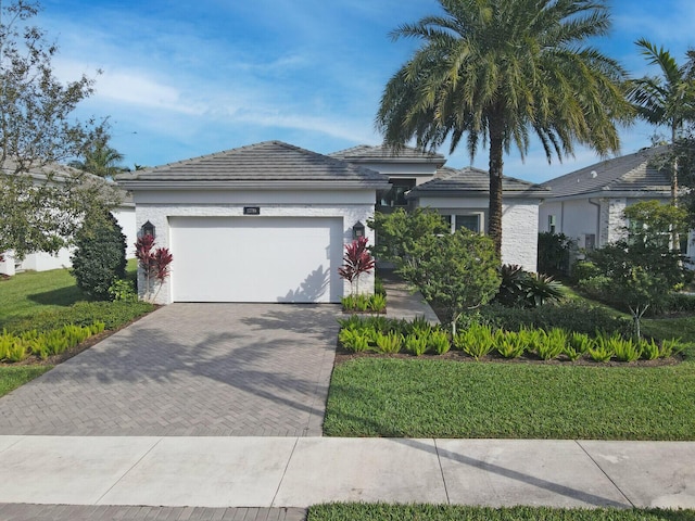 view of front of house with a front lawn and a garage