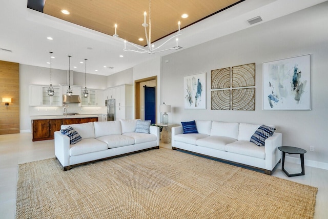 living room with an inviting chandelier and sink