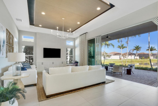 tiled living room with a raised ceiling, a towering ceiling, wooden ceiling, and ceiling fan with notable chandelier