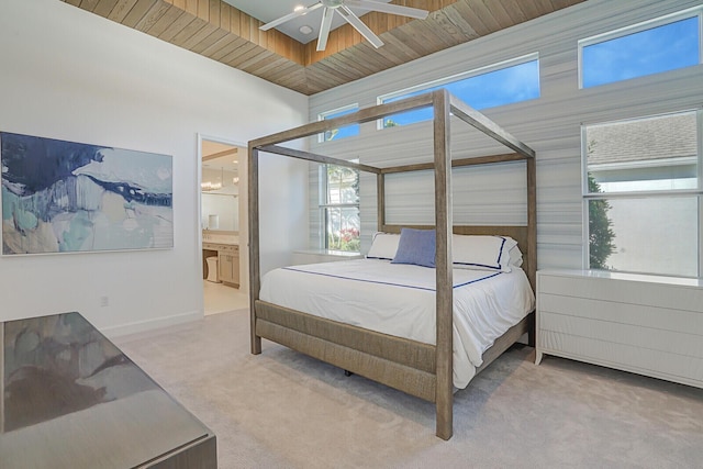 bedroom with carpet flooring, ensuite bathroom, ceiling fan, and wood ceiling