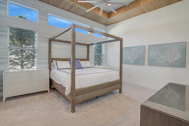 carpeted bedroom featuring multiple windows and ceiling fan