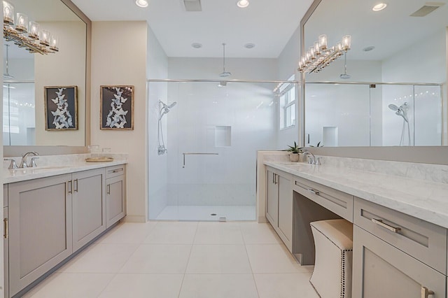 bathroom featuring tile patterned flooring, vanity, and a shower with door