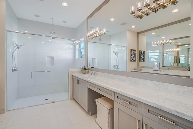 bathroom featuring vanity, tile patterned floors, and a shower with shower door