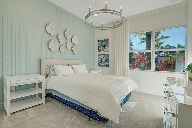 bedroom with light colored carpet, an inviting chandelier, and wooden walls