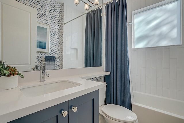 full bathroom with shower / tub combo with curtain, vanity, and toilet