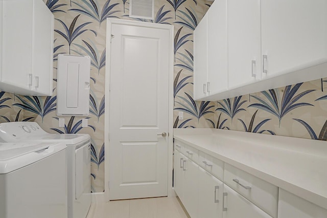 washroom featuring cabinets, washer and dryer, and light tile patterned flooring