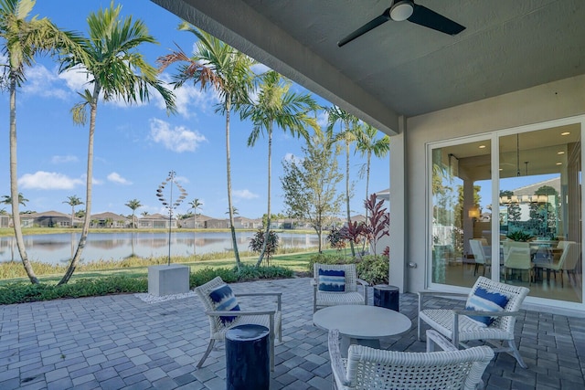 view of patio / terrace featuring ceiling fan and a water view