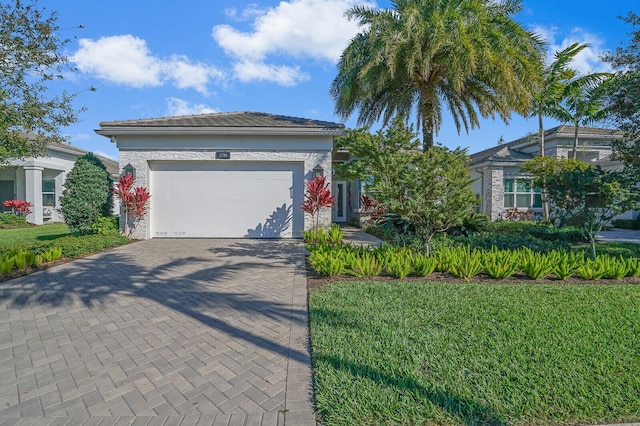 view of front of house featuring a front yard and a garage