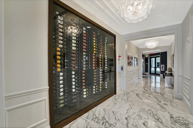 wine cellar featuring french doors, an inviting chandelier, and crown molding