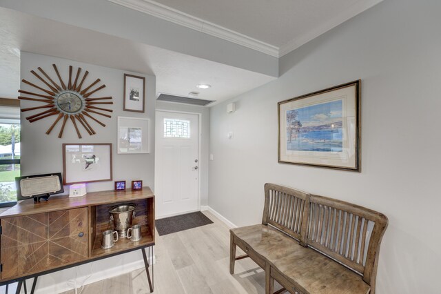 office area with crown molding, ceiling fan, and light wood-type flooring