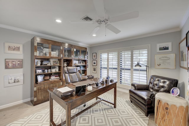 office space with a ceiling fan, visible vents, crown molding, and light wood finished floors