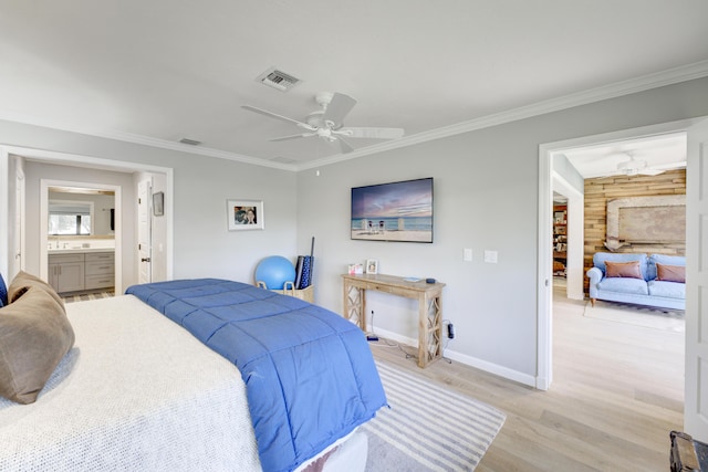 bedroom with ornamental molding, light wood-type flooring, visible vents, and baseboards