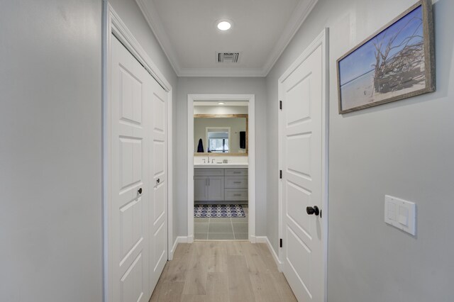 hallway featuring recessed lighting, light wood-type flooring, visible vents, and crown molding