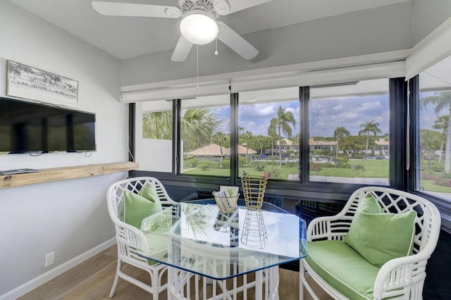 sunroom featuring ceiling fan