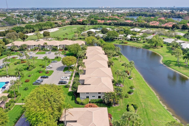 birds eye view of property featuring golf course view, a water view, and a residential view