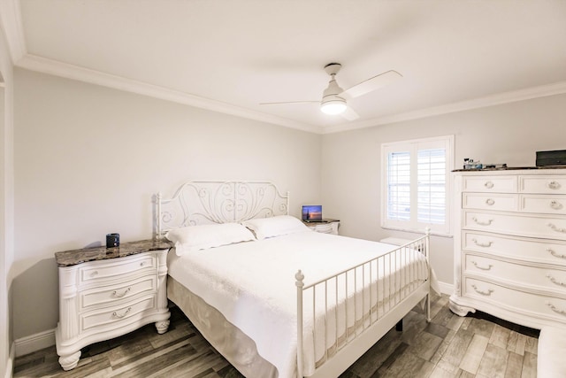 bedroom with ceiling fan, crown molding, baseboards, and wood finished floors